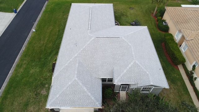 An aerial view of a house with a new roof.