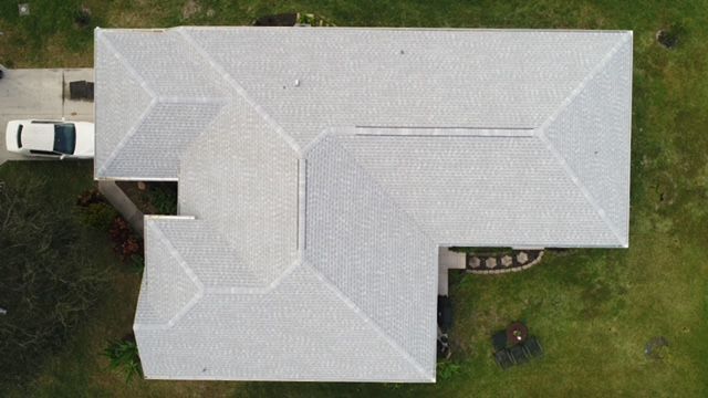 An aerial view of a house with a white truck parked in front of it.