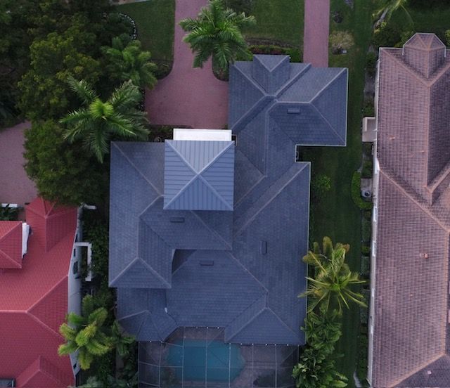 An aerial view of a house with a blue roof