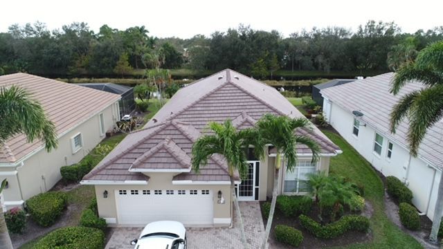 An aerial view of a house with a car parked in front of it