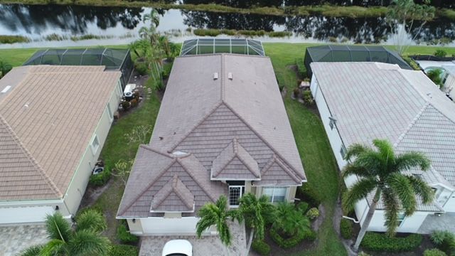 An aerial view of a house with a car parked in front of it.