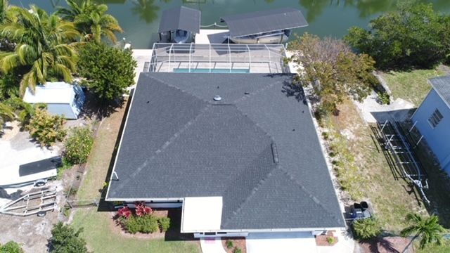 An aerial view of a house with a black roof