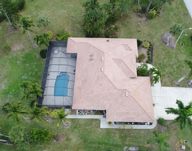 An aerial view of a house with a pool in the backyard.