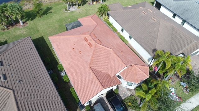 An aerial view of a house with a red tile roof.