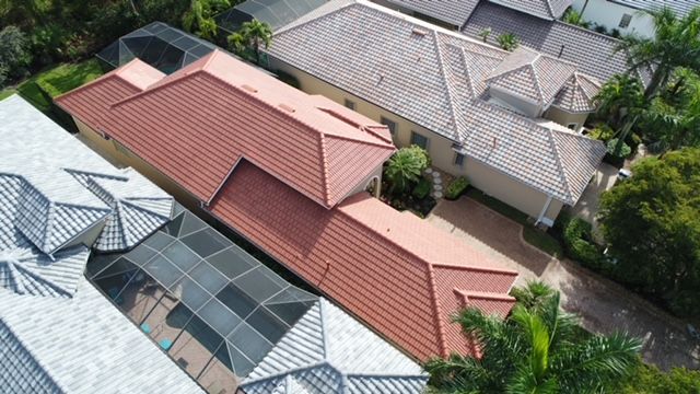 An aerial view of a row of houses with red tile roofs.