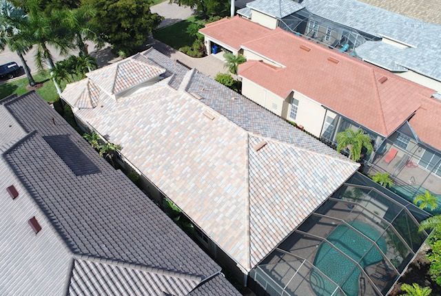 An aerial view of a house with a pool in the backyard.