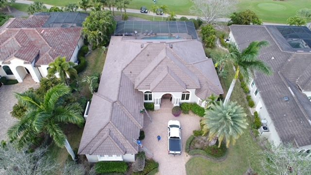 An aerial view of a large house with a truck parked in front of it.