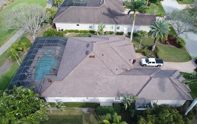 An aerial view of a house with a truck parked in front of it.