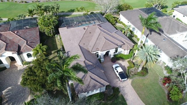 An aerial view of a house with a car parked in front of it.
