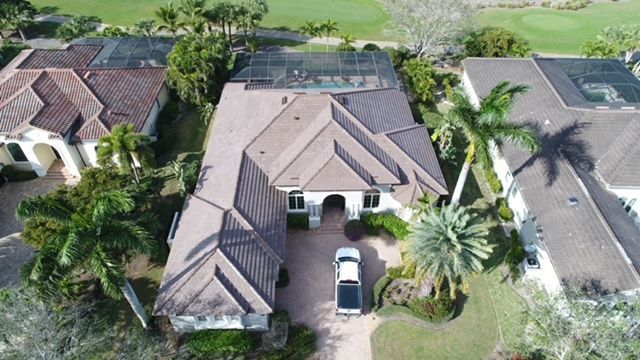 An aerial view of a house with a truck parked in front of it