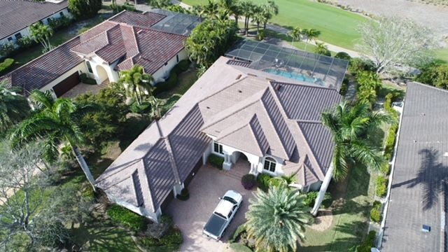 An aerial view of a house with a truck parked in front of it.