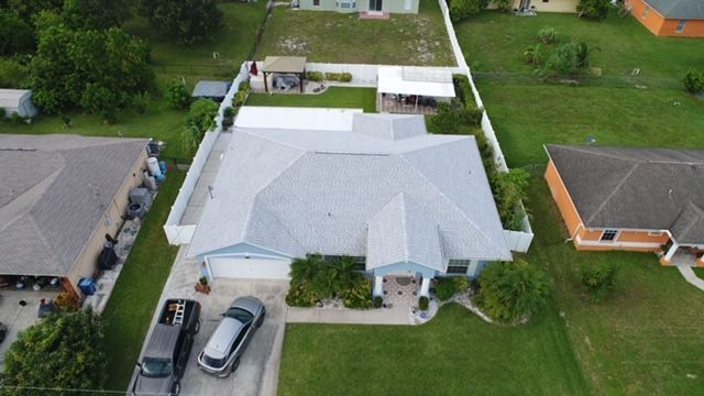An aerial view of a house with a white van parked in front of it.