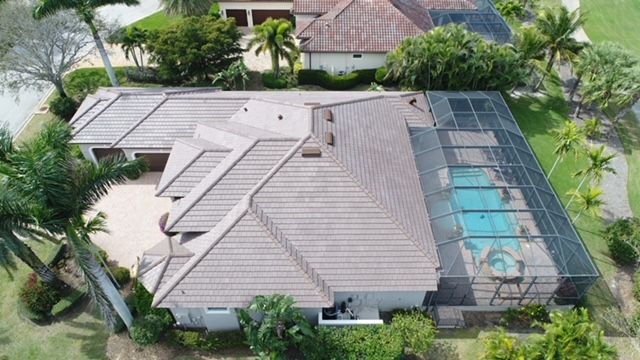An aerial view of a house with a pool in the backyard.