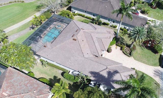 An aerial view of a house with a pool in the backyard.