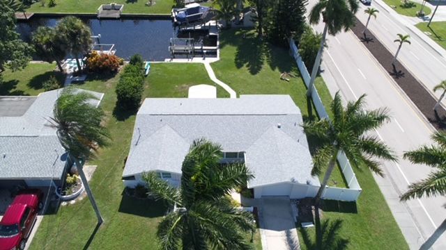An aerial view of a house with a red truck parked in front of it