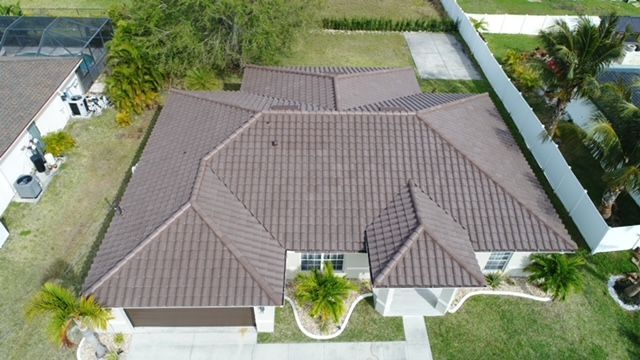 An aerial view of a house with a brown tile roof.