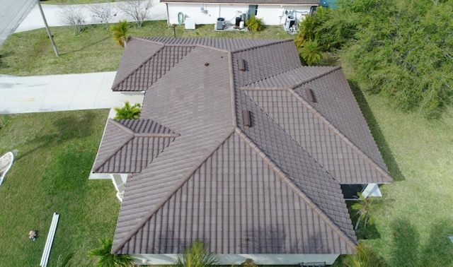 An aerial view of a house with a brown tile roof.