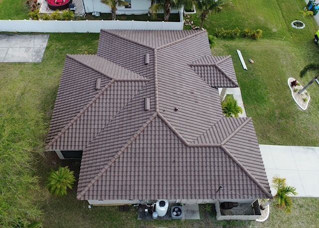 An aerial view of a house with a brown tile roof.