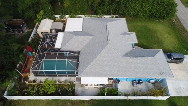 An aerial view of a house with a pool