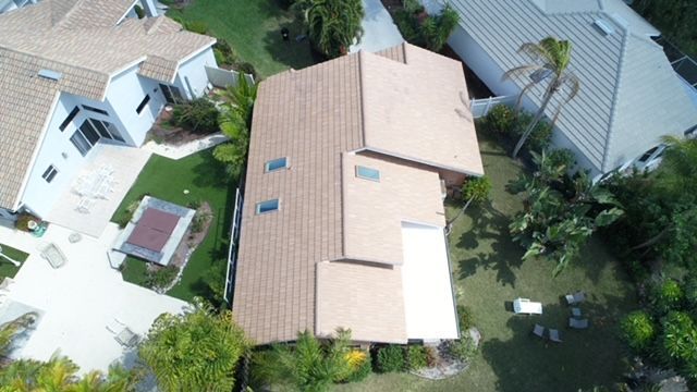 An aerial view of a house with a roof that has two skylights.