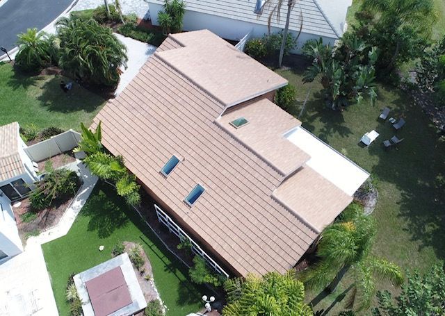 An aerial view of a house with a brown roof