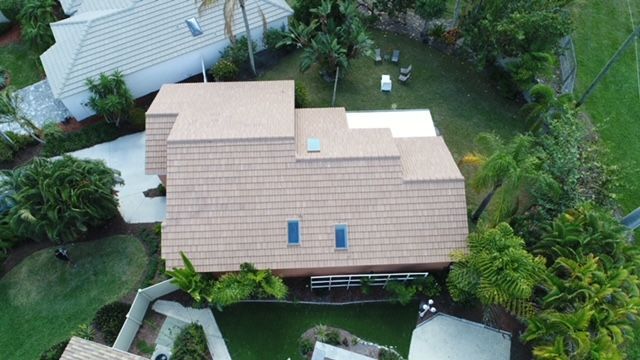 An aerial view of a house with a brown roof