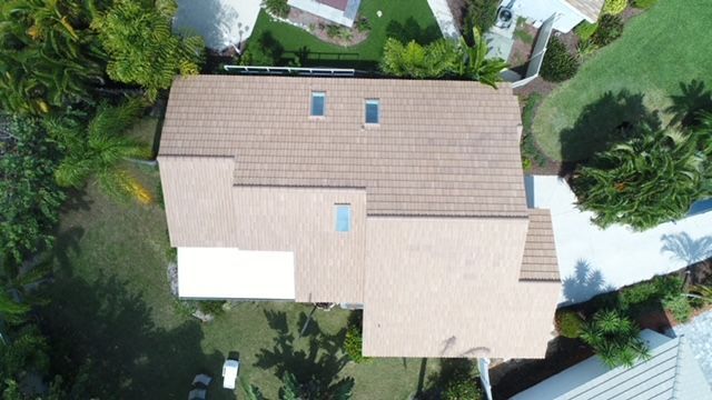 An aerial view of a house with a tiled roof and two skylights.