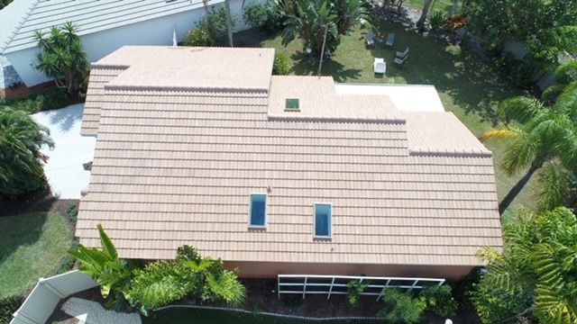 An aerial view of a house with a tiled roof and two skylights.