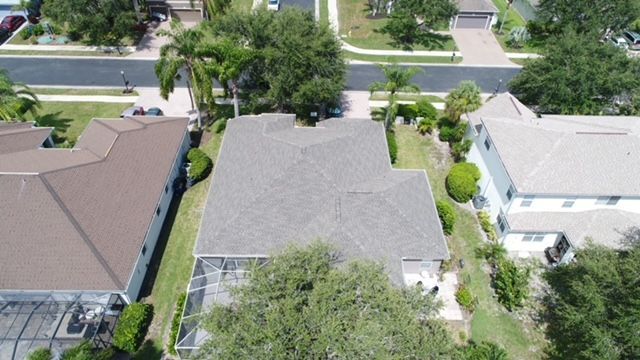 An aerial view of a residential neighborhood with houses and trees.