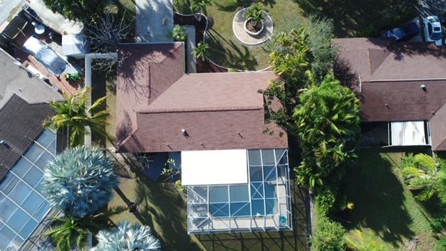 An aerial view of a house with a pool in the backyard