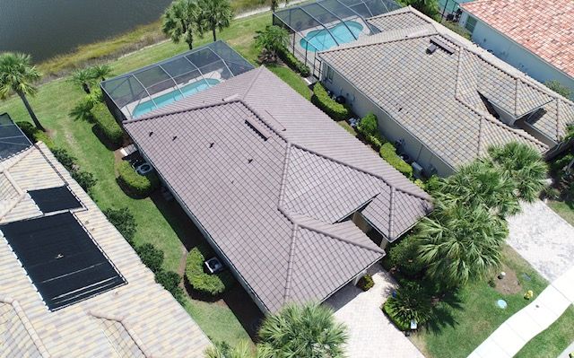 An aerial view of a house with a pool and solar panels on the roof.