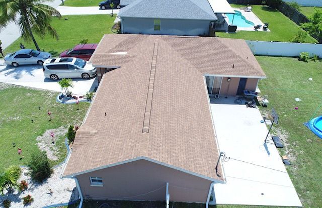An aerial view of a house with a pool in the backyard