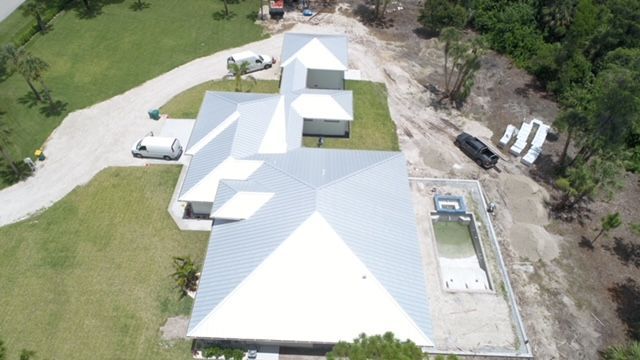 An aerial view of a house with a swimming pool