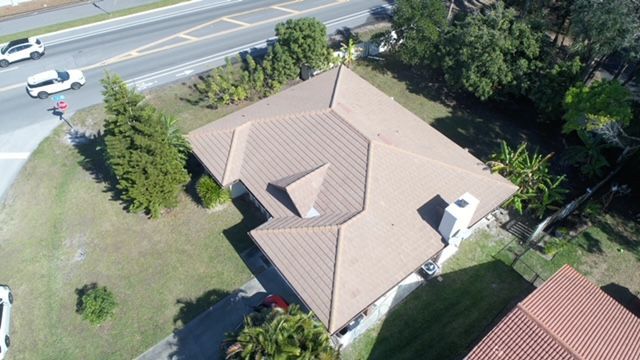 An aerial view of a house with a brown roof
