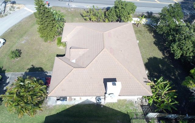 An aerial view of a house with a brown roof