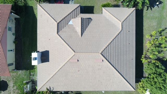 An aerial view of a house with a triangle shaped roof.