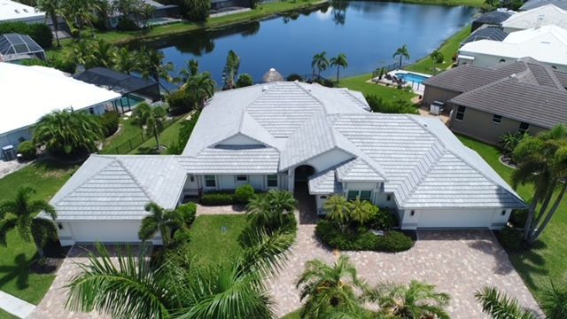 An aerial view of a house with a white roof