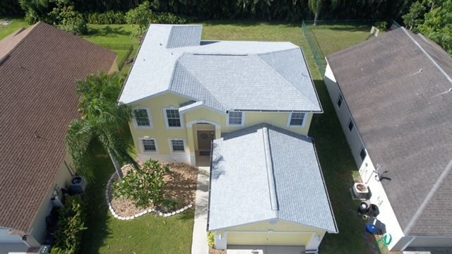 An aerial view of a house with a gray roof