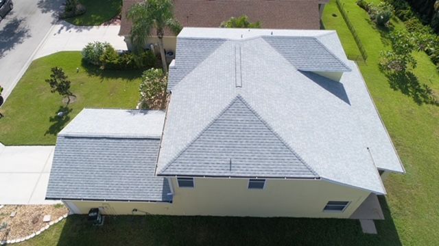 An aerial view of a house with a new roof.