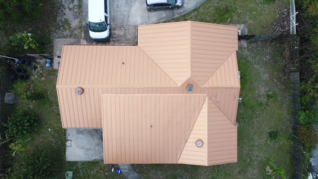 An aerial view of a house with a copper roof.