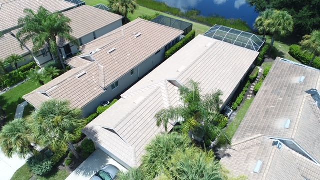 An aerial view of a row of houses with a car parked in front of them.