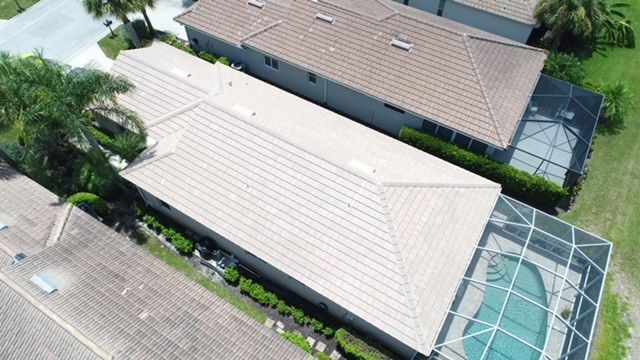 An aerial view of a house with a pool in the backyard.