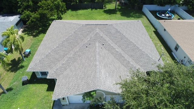 An aerial view of a house with a new roof.