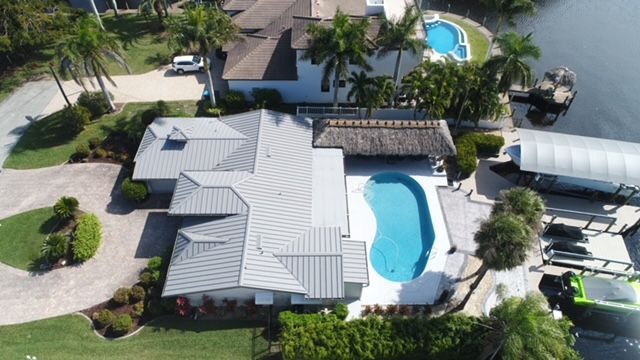 An aerial view of a large house with a pool