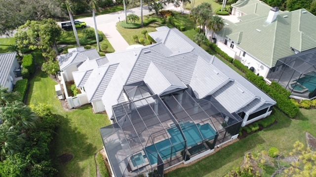 An aerial view of a house with a pool in the backyard.