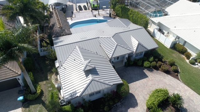 An aerial view of a house with a pool in the backyard.