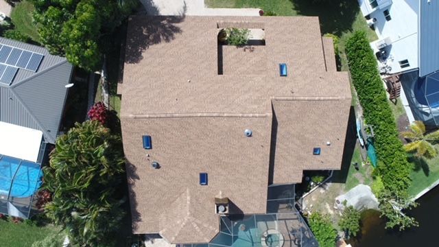 An aerial view of a house with a brown roof