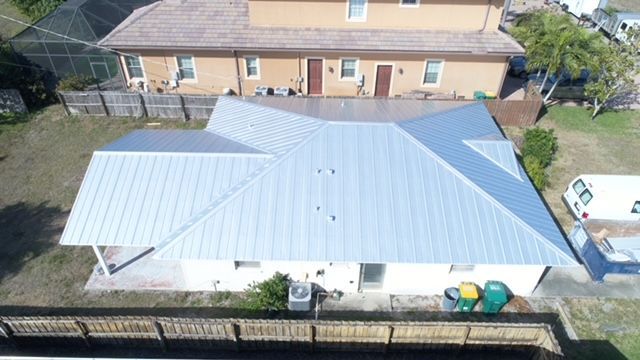 An aerial view of a house with a metal roof