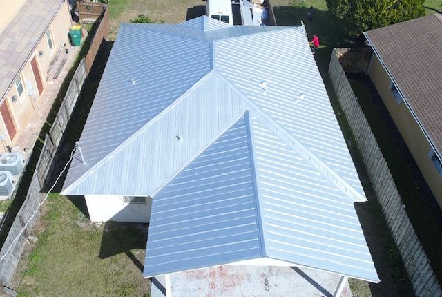 An aerial view of a house with a metal roof