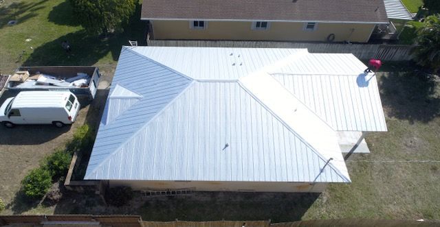 An aerial view of a house with a white van parked in front of it.